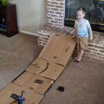 My son with a ramp to make a simple machine projects.