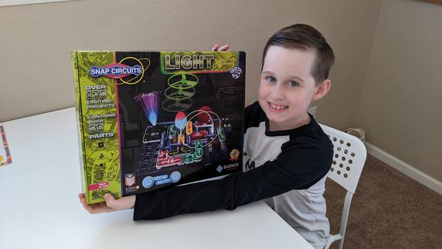 My son holding the Snap Circuits box