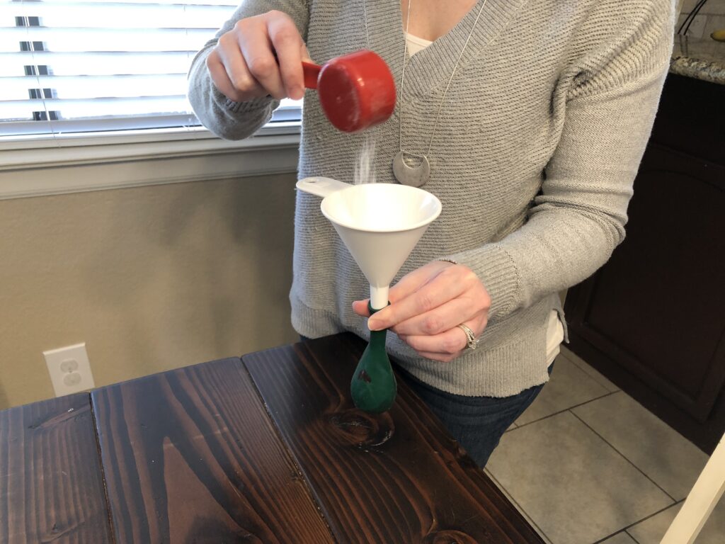 adding baking soda to the balloon