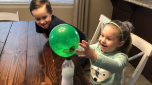 Kids doing the Baking Soda and Vinegar Balloon Experiment