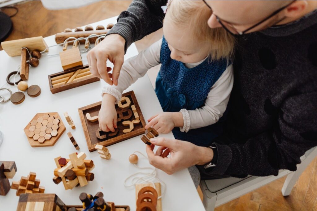 Person Helping Child with Project