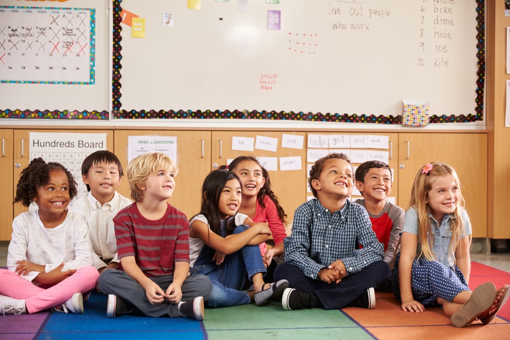 Elementary school kids sitting on classroom floor