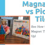 A girl with Magna Tiles and Picasso Tiles