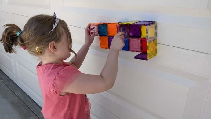 Playing with Magna tiles on the garage door