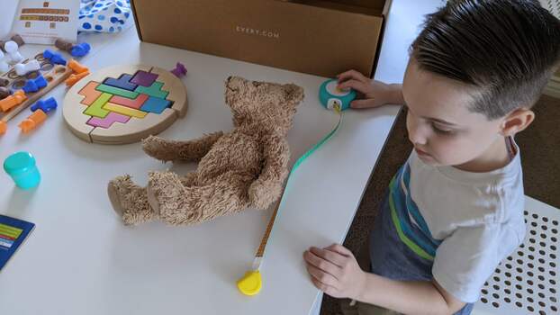 Measuring his bear