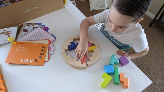 Toddler solving puzzle wheel