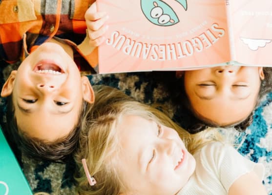 Toddlers reading books in a group