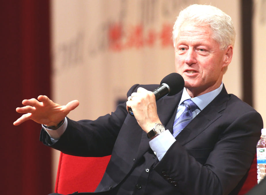 bill clinton talking with mic in his hand.