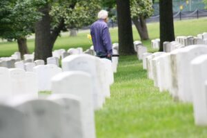 old man walking around the cementery.