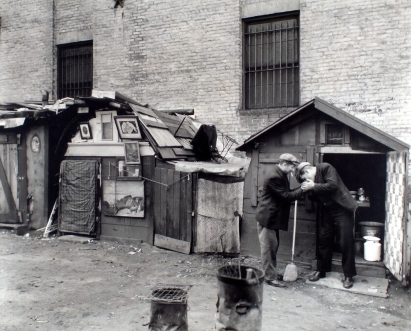 poor men outside their home.