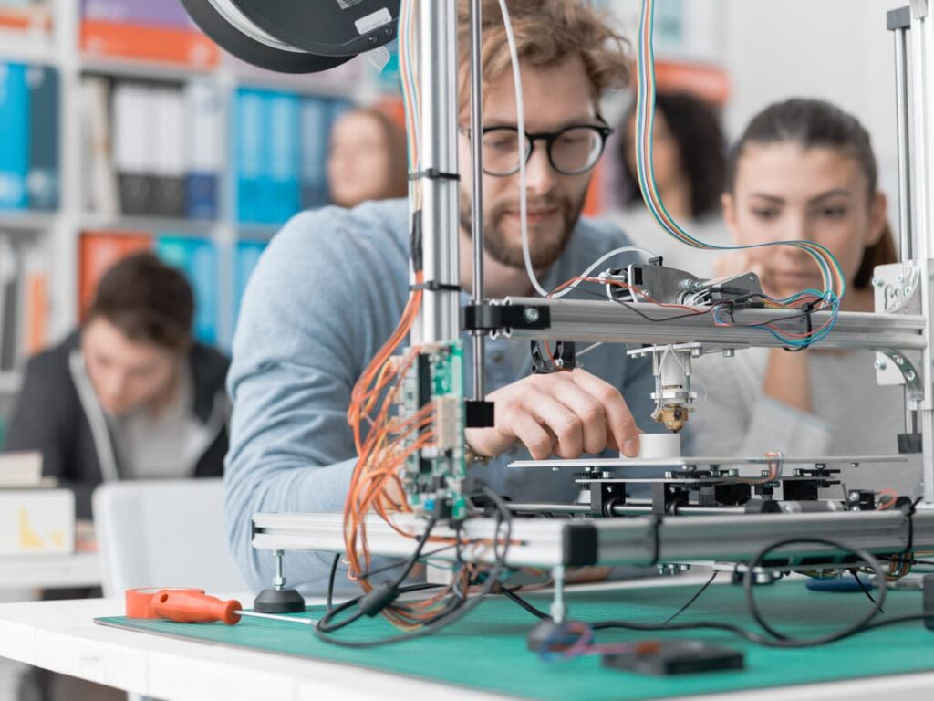 Engineering STEM students using 3D printer.