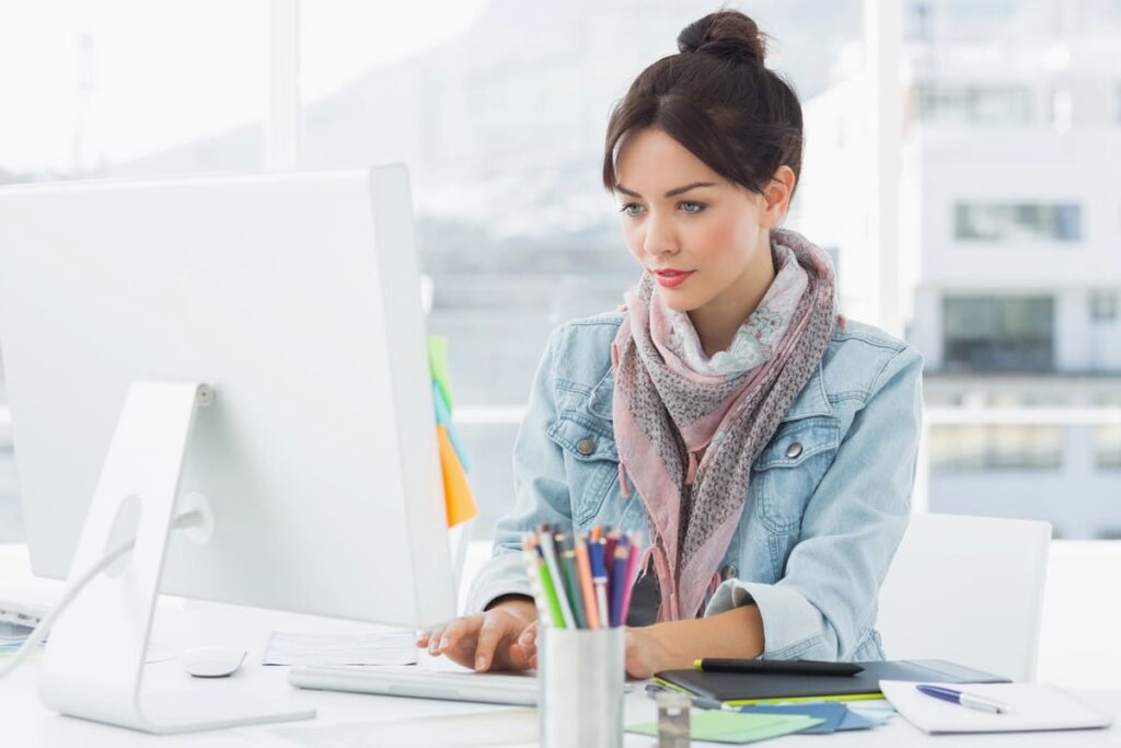 Young women working in an office on her computer.