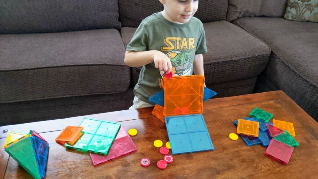 My son learning with magnetic tiles.