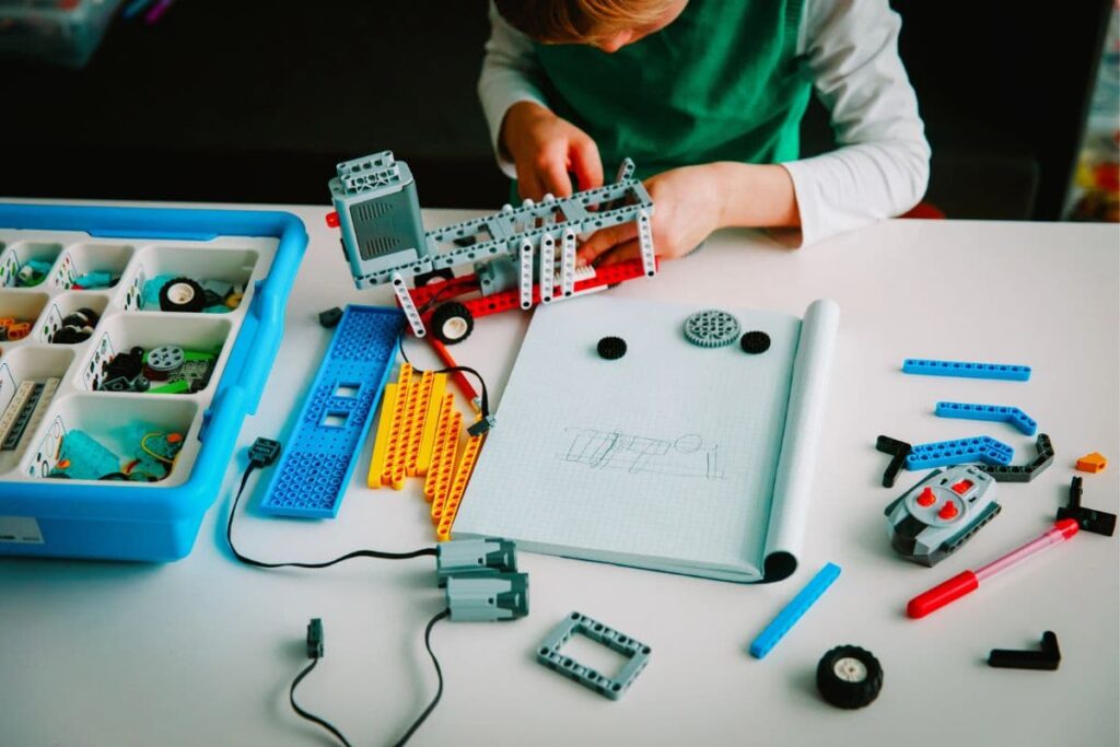 boy fixing xylophone in makerspace